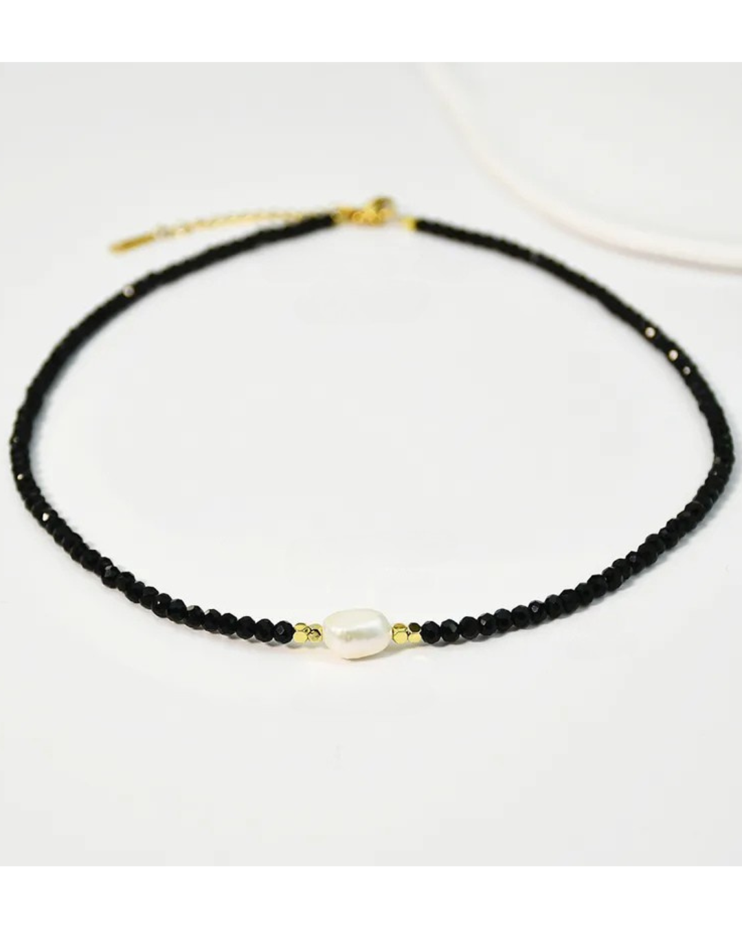 The 'Dark Light' necklace with a medium size abstract fresh water pearl